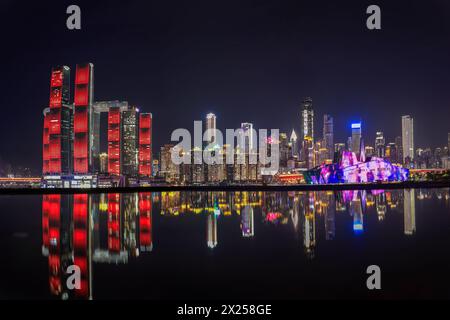 Chongqing, China - October 20. 2023: Panorama night scene of Chongqing skyscapers with its business center over the Yangtze River Stock Photo