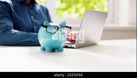 Save Money Online Using Bank Piggy And Laptop Computer Stock Photo