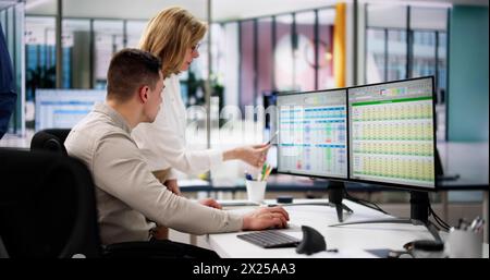 Analyst Employee Working On Spreadsheet Using Desktop Computer Stock Photo