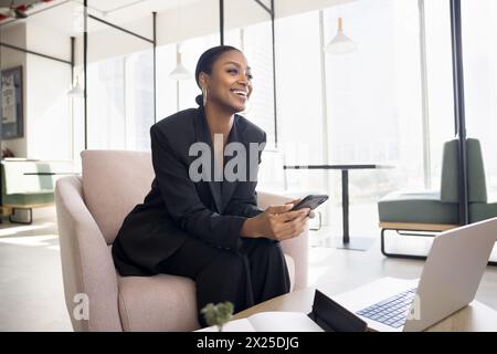 Happy attractive young African American business lady using Internet technology Stock Photo