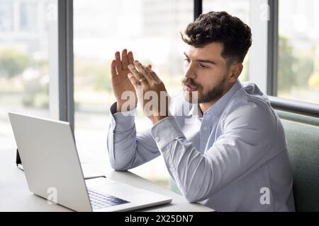 Serious young Arab project manager man talking to client Stock Photo