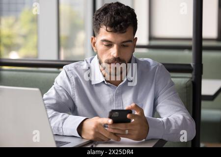 Focused handsome Arab freelance professional man using modern online technology Stock Photo