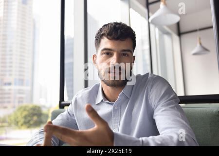 Serious young business professional man talking on video call Stock Photo