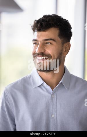 Cheerful handsome Arab professional man in formal shirt looking away Stock Photo
