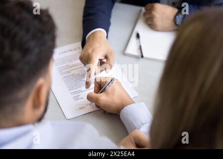 Legal expert pointing finger at space for signature in paper Stock Photo