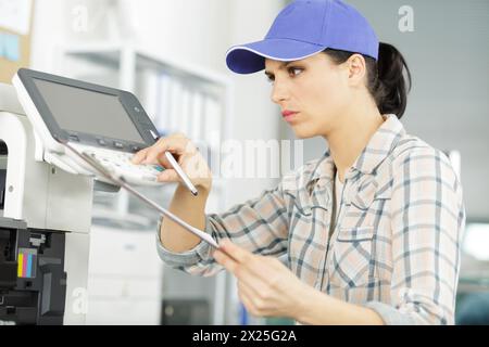 woman fixing a printer Stock Photo