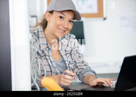 female programmer coding on a desktop computer Stock Photo