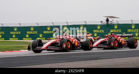 Shanghai. 20th Apr, 2024. Ferrari's driver Charles Leclerc (L) of Monaco and his teammate Spanish driver Carlos Sainz compete during the Sprint Race of Chinese Formula One Grand Prix at the Shanghai International Circuit in east China's Shanghai, on April 20, 2024. Credit: Xia Yifang/Xinhua/Alamy Live News Stock Photo