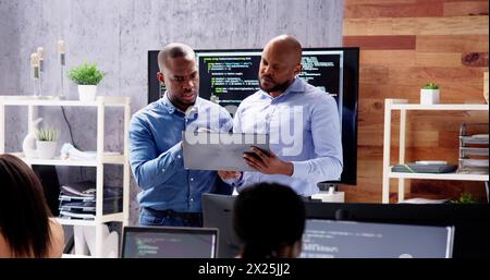 African team of programmers working on computer code for business Stock Photo