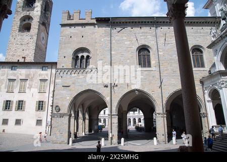 Romanesque Torre Civica (Civic Tower) from XI to XII century and Gothic Palazzo della Ragione from XII century on Piazza Duomo in historic centre call Stock Photo