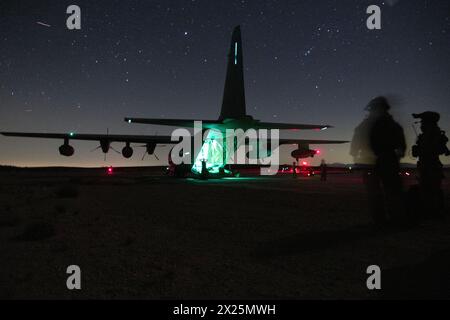 A U.S. Marines Corps KC-130J Hercules aircraft assigned to Marine Aviation Weapons and Tactics Squadron One, participates in a Noncombatant Evacuation Stock Photo