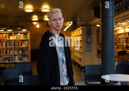 a young handsome guy studies in a co-working space. Library for students Stock Photo