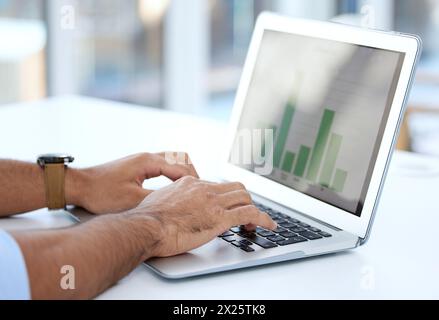 Hands, laptop and typing with graphs on screen, enter data on spreadsheet and analyst for analytics and research. Business person with analysis Stock Photo