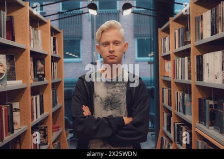 Portrait of a handsome Scandinavian student in a modern library Stock Photo
