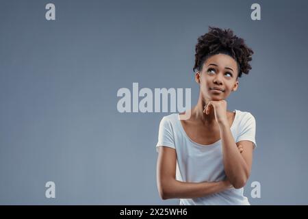 Idea in motion, a confident Black woman gestures upward with purpose Stock Photo