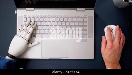 Man With Prosthetic Hand Working On Laptop. Artificial Limb Stock Photo