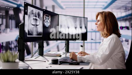 Dentist Doctor Looking At Teeth Xray On Computer Stock Photo
