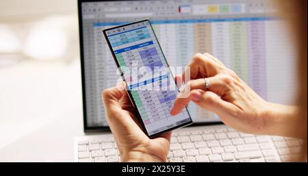 Spreadsheet Data Analyst Using Computer Software On Phone Stock Photo