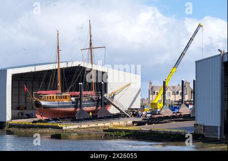 Buckie Harbour, Moray, UK. 19th Apr, 2024. This is the Sailing Boat, Kommandoren bearing a UK Flag dry docked at Macduff Shipyards in Buckie. This Baltic Trader was built in 1891 and is currently owned by Hays Ships. Credit: JASPERIMAGE/Alamy Live News Stock Photo