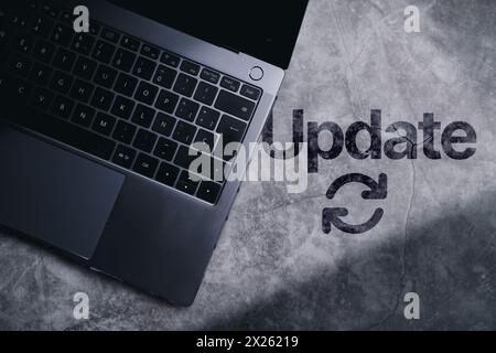 Desktop top view with laptop and the word update written on surface. Software upgrade concept with empty space for use. Stock Photo