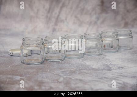 Small glass jars for sauce, jam on gray background . space for your text Stock Photo