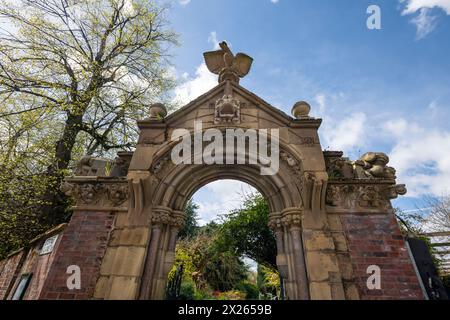 Stone arch at the entrance to the Parsonage Garden, Fletcher Moss botanical garden at Didsbury in South Manchester. Stock Photo