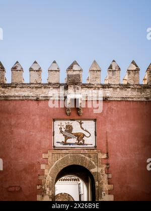 The ceramic panel showing a lion on the Lion Gate (Puerta del Leon) over the main entrance to the Real Alcazar de Seville Stock Photo