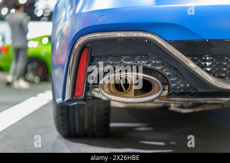 dynamic energy of a sport car's exhaust pipe. This close-up shot captures the intense power and performance of the vehicle, highlighting its sleek des Stock Photo