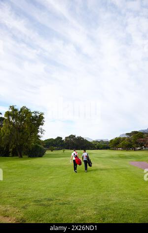 People, ready and golf course for professional sport and walking on grass for training with mockup on field. Athlete, talking and friends with golfing Stock Photo