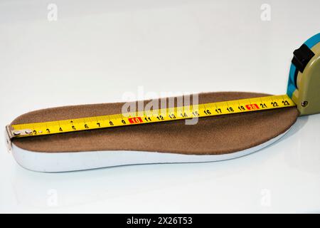 Shoe size measurement. Measure tape measure insoles. shoes size concept. close-up.  measure footwear scale . footwear Size Guide Stock Photo