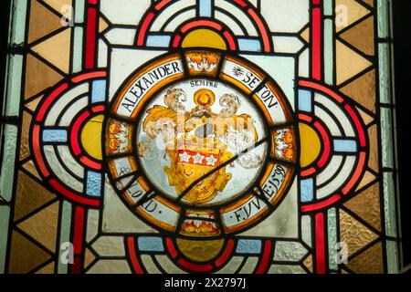 Ancient and colourful stained glass window with family crest in Fyvie castle Stock Photo