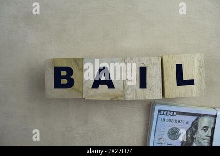 Concept of The wooden Cubes with the word BAIL on wooden background. Stock Photo