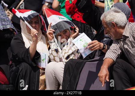 Mosul, Iraq. 20th Apr, 2024. Iraqi women hold Iraqi flags during Spring Festival activities in the celebration area in the city of Mosul, northern Iraq. The festival is being held for the second year in a row since it stopped for two decades after 2003 due to the US invasion on Iraq. Spring celebrations go back to the era of the Assyrians, who celebrated the spring season and the beginning of the Assyrian year Akitu. The beginning of this festival in Mosul was in 1969 AD. Credit: SOPA Images Limited/Alamy Live News Stock Photo