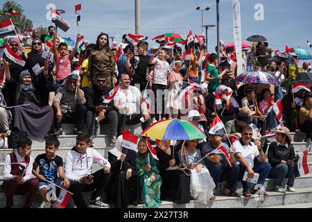 Mosul, Iraq. 20th Apr, 2024. People hold Iraq flags during Spring Festival activities in the celebration area in the city of Mosul, northern Iraq. The festival is being held for the second year in a row since it stopped for two decades after 2003 due to the US invasion on Iraq. Spring celebrations go back to the era of the Assyrians, who celebrated the spring season and the beginning of the Assyrian year Akitu. The beginning of this festival in Mosul was in 1969 AD. Credit: SOPA Images Limited/Alamy Live News Stock Photo