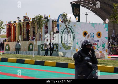 Mosul, Iraq. 20th Apr, 2024. A police officer seen on guard during spring festival celebration in northern Iraq. The festival is being held for the second year in a row since it stopped for two decades after 2003 due to the US invasion on Iraq. Spring celebrations go back to the era of the Assyrians, who celebrated the spring season and the beginning of the Assyrian year Akitu. The beginning of this festival in Mosul was in 1969 AD. (Photo by Ismael Adnan/SOPA Images/Sipa USA) Credit: Sipa USA/Alamy Live News Stock Photo