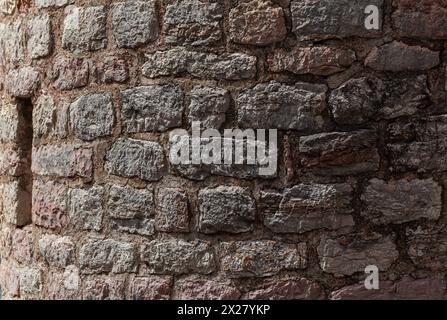 Stone texture of a wall in Montenegro. An ancient wall made of brown coloured stones. Background. Template. For design. Horizontal. Stock Photo