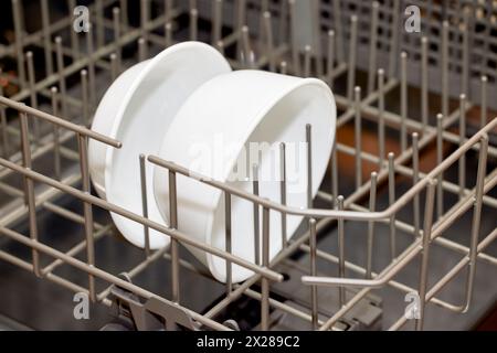 Close up of two white ceramic bowls in the lower rack of a dishwasher Stock Photo