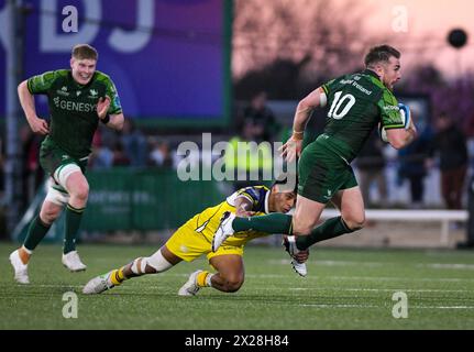 Galway, Ireland. 20th April, 2024. Connacht's JJ Hanrahan tries to break from a tackle Credit: Don Soules/Alamy Live News Stock Photo