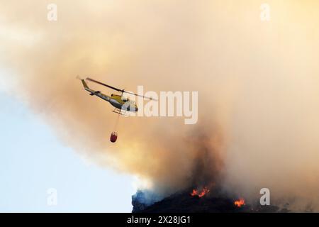 Helicopter dropping water on wildfire Stock Photo