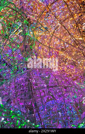 Abstract pattern of multicolored garlands, bokeh on dark background. Stock Photo