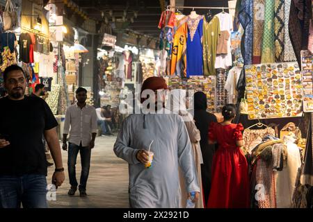 Muscat, Oman - February 13 2023: Arab men wearing the traditional thawb walk through the traditional Mutrah Souq, or bazar, in Muscat in Oman capital Stock Photo