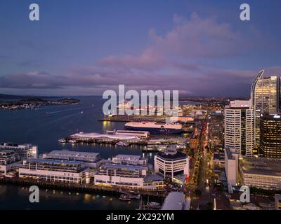 Auckland, New Zealand - July 24 2023: Dramatic sunset over  Auckland central business district skyline , the ancient ferry terminal and commerical har Stock Photo