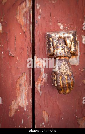 Rusted Hand Door Knocker Stock Photo