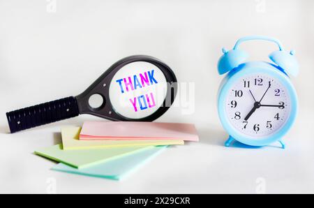 Thank you, magnifying glass with words on a white background with stickers and a clock Stock Photo