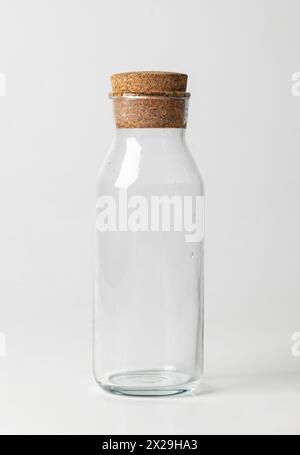 Empty glass jar with brown corke isolated on white background. Stock Photo