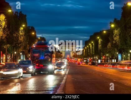 Illuminated Champs Elysee and view of Arc de Triomphe in parisian evening, France Stock Photo