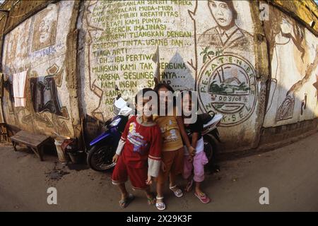 Kids playing by pro-Sukarno graffiti, Pejaten, Jakarta, Indonesia Stock Photo