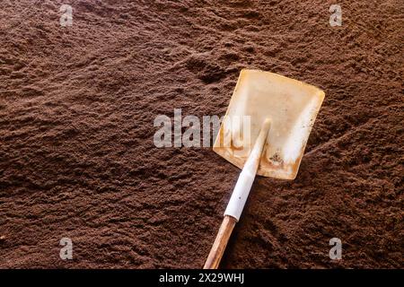 Shovel on pile of tea during producing process in tea factory in Sri Lanka. Stock Photo
