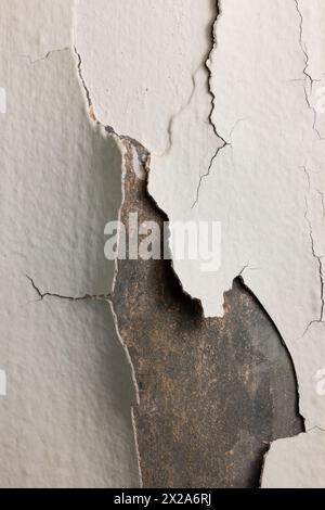 A closeup of white pealing paint on a metal duct. Stock Photo