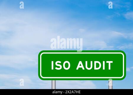 Green color transportation sign with word ISO audit on blue sky with white cloud background Stock Photo